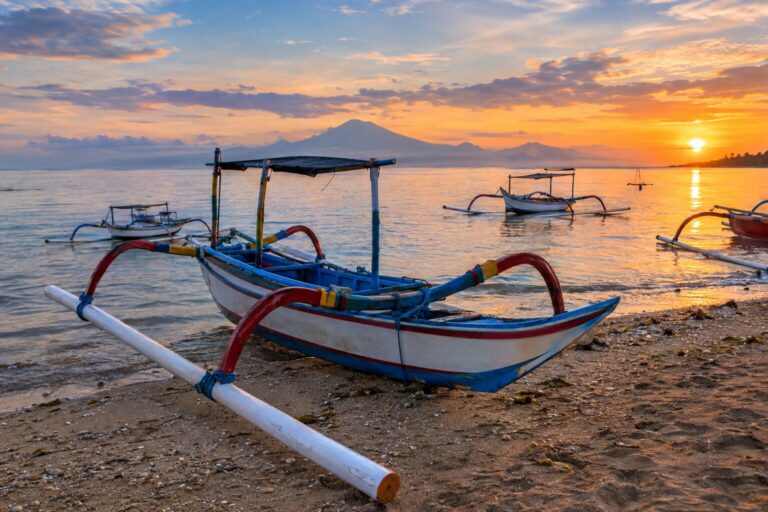 Traditionele houten vissersboten met dubbele uitleggers op het strand van Mertasari in Sanur